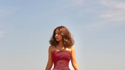 Hina Khan in a dramatic red, strapless, pleated-skirt gown. Photo: Rami Al Ali