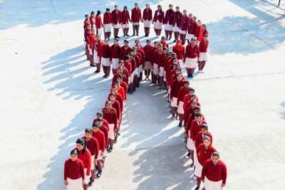 School students stand in the shape of a ribbon as part of an awareness event in Amritsar, India on Saturday. AFP
