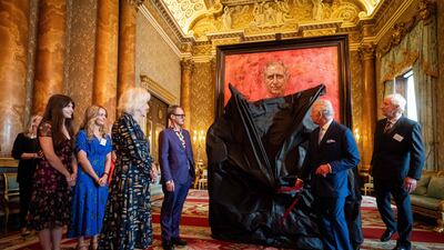 Britain's Queen Camilla watches as King Charles III unveils an official portrait of himself, by artist Jonathan Yeo, fifth left. AFP
