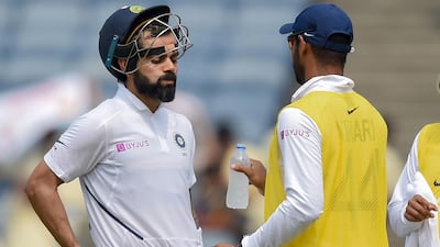 Virat Kohli, left, takes a break in Pune. AFP