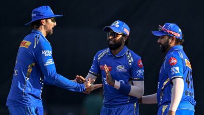 Mumbai Indians' captain Hardik Pandya, centre, celebrates with teammates Tim David and Rohit Sharma after the dismissal of Delhi Capitals' David Warner. Mumbai won the Indian Premier League game by 29 runs at the Wankhede Stadium in Mumbai on April 7, 2024. AFP