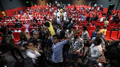 Fans react to his appearance on the screen. EPA
