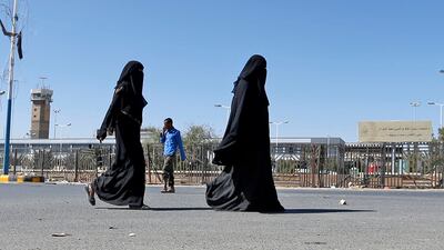 Women walk by the almost deserted airport. AFP