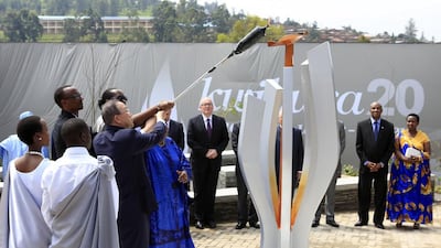 United Nations Secretary General Ban Ki-moon and Rwandan President Paul Kagame light a symbolic flame in Kigali April 7, 2014. . Noor Khamis / Reuters