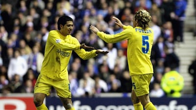 Diego Forlan and Juan Roman Riquelme celebrate after scoring during the UEFA Champions League match between Villarreal and Rangers. Jeff J Mitchell / Getty