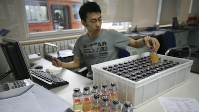 In this file photo from June 2008, urine samples from Chinese athletes are recorded upon arriving at China Anti-Doping Agency in Beijing. The IOC said Friday, July 22, 2016, that 45 more athletes ‚ including 23 medalists, have been caught for doping in retesting of samples from the 2008 and 2012 Olympics. Robert Bukaty / AP Photo