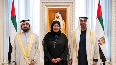 ABU DHABI, UNITED ARAB EMIRATES - December 11, 2024: HH Sheikh Mohamed bin Zayed Al Nahyan, President of the United Arab Emirates (R) and HH Sheikh Mohamed bin Rashid Al Maktoum, UAE Vice President, Prime Minister and Ruler of Dubai (L), stand for a photograph during an oath swearing-in ceremony for newly appointed UAE Cabinet Minister, HE Sana bint Mohamad Suhail UAE Minister of Family (C), at Qasr Al Watan. ( Abdulla Al Neyadi / UAE Presidential Court ) ---
