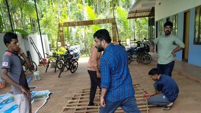 The giant cut-outs of three of the world's best players are the centrepiece of this unlikely hotbed of football. Pullavoor football fans