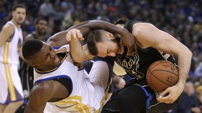Golden State Warriors’ Festus Ezeli, left, fouls Milwaukee Bucks’ Miles Plumlee during the first quarter of an NBA basketball game in Oakland, California. Ben Margot / AP