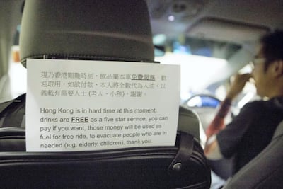 A sign in the back of an Uber driver's car shows that any donations and money given will go towards helping fund his role in being part of the 'school bus' system. Rick Findler for The National