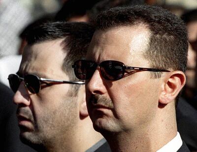 Bashar Al Assad and his brother Maher, left, attend the funeral of their father, Hafez, in Damascus in June 2003. AFP
