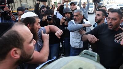Palestinians argue with Israeli settlers a day after a shooting attack and violence in the West Bank town of Hawara. EPA
