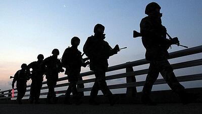 South Korean marines patrol along the seashore on Yeonpyeong Island. Shin Jun-hee / Yonhap / Reuters