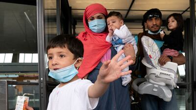 Families flown from Kabul, Afghanistan, arrive at Washington Dulles International Airport, in Chantilly, Virginia. AP