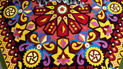 Volunteers place flowers and petals to form designs as part of The Flower Project which sees more than 300,000 dahlia flowerheads displayed in a 29 metre wide design inspired by the area's textile history by local artist Shiraz Ali in Bradford, Britain. Reuters