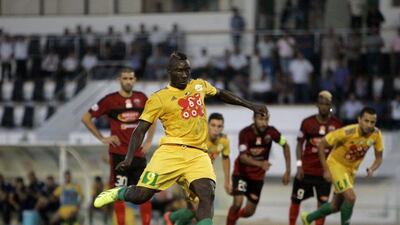 JS Kabylie's Cameroonian striker Albert Ebosse, centre, was hit by a projectile thrown from the stands during his Algerian club's match on Saturday. He later died from the injury. AFP Photo / August 23, 2014