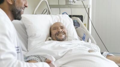 Saif Zarouta, who was given just eight months to live but is now confident after a successful operation, talks to his surgeon, Ali Aldameh, at Al Zahra Hospital Reem Mohammed / The National