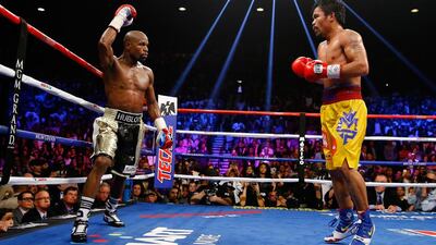Floyd Mayweather Jr, left, beat Manny Pacquiao in May last year. Al Bello / Getty Images / AFP