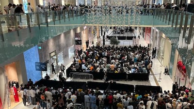People queue for the iPhone 15 at Dubai Mall in Dubai. John Dennehy / The National