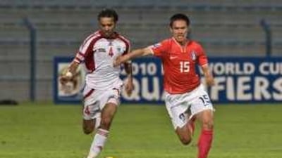 The UAE's Mohammad Qassim, left, chases after South Korea's Bae ki-Jong on Saturday.