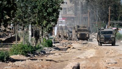 Israeli armoured vehicles leave after a raid on the Nur Shams refugee camp near Tulkarm on Thursday, amid a surge of violence in the occupied West Bank AFP