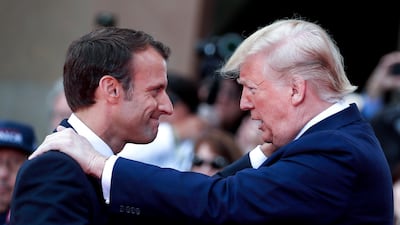 US President Donald Trump talks with French President Emmanuel Macron during a French-US ceremony in Normandy as part of D-Day commemorations marking the 75th anniversary of the World War II Allied landings. AFP