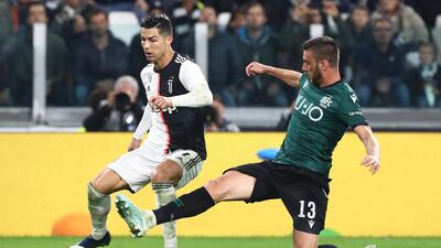 Cristiano Ronaldo of Juventus FC competes for the ball with Mattia Bani of Bologna FC during the Serie A match between Juventus and Bologna FC at Allianz Stadium in Turin, Italy. Getty Images