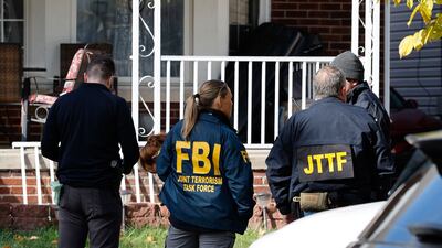 FBI agents outside a home in Dearborn, Michigan, during a search there on Friday. AFP