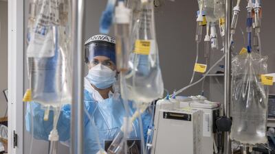 A medical staff member checks on a patient's intravenous drip device in the Covid-19 intensive care unit at the United Memorial Medical Center in Houston, Texas, USA. AFP
