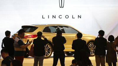 Visitors take photos of a Lincoln MKX SUV concept car during Auto China 2014 in Beijing, on April 20. Jason Lee / Reuters