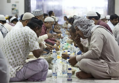 Faithful Muslims eating iftar at the Kuwaiti Mosque. Leslie Pableo / The National