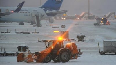 Ground maintenance staff clear snow at Frankfurt airport.