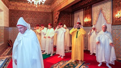 Moroccan King Mohammed VI Commander of the Faithful, third right, flanked at left by the Crown Prince Moulay El Hassan and his brother Prince Moulay Rachid, fourth left, pray during Eid Al Fitr at the residence of Sale near Rabat. AP