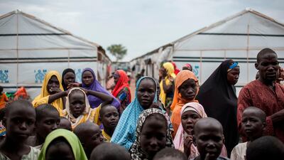 People gather outside a tent in one of the Internally Displaced People camps in Pulka, Borno State. AFP