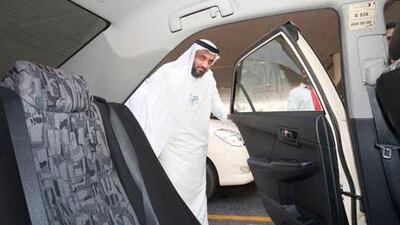 Yousif Mohammed Al Ali, CEO of Dubai Taxi Corporation, checks out the interior of a taxi at Dubai airport.