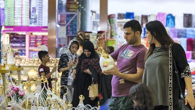 Shoppers check out items at a Ramadan Market in Dubai. Leslie Pableo / The National