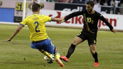 Belgium's Eden Hazard fights for the ball with Sweden's Mikael Lustig during their international friendly on Sunday in Stockholm. Ints Kalnins / Reuters / June 1, 2014