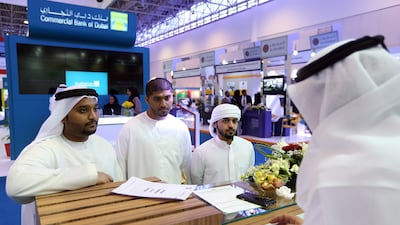 Emiratis submit job applications during the National Career Exhibition in Sharjah. Satish Kumar / The National
