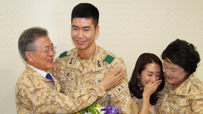 South Korean President Moon Jae-in and his wife Kim Jung-sook embrace Captain Lee Jae-woo and his fiancee Lee Dabomi in a gesture congratulating the couple on their planned marriage, as he visits a contingent of the Akh unit. EPA / Yonhap