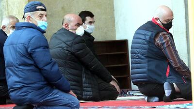 Bosnian Muslim men wearing protective face masks pray in the Gazi Husrev-beg Mosque in Sarajevo, Bosnia and Herzegovina. EPA
