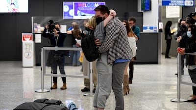 A couple embrace as they are reunited as the US reopens air and land borders to vaccinated travellers for the first time since Covid-19 restrictions were imposed. AFP