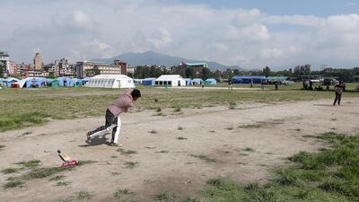 Boys play cricket at the Tundikhel relief camp in Kathmandu. Pawan Singh / The National