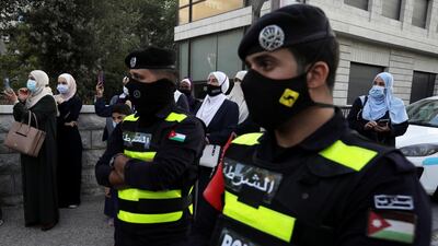 Police officers stand guard as Jordanian women attend a protest against cartoon publications of Prophet Mohammad in France and French President Emmanuel Macron's comments, near the French Embassy in Amman, Jordan. REUTERS