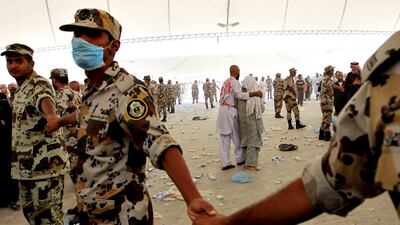 Saudi soldiers cordon off Muslim pilgrims throwing stones at the symbolic devil represented by a Jamarat during the last day of the Muslim's Hajj. Alaa Badarneh / EPA