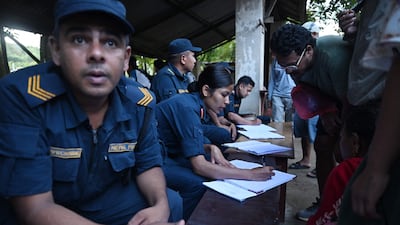 Nepali police at Trishuli army camp gather information about people missing since the floods struck. AFP