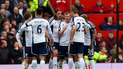 Chris Brunt, centre-right, of West Brom celebrates with teammates after taking a free-kick that was deflected off Jonas Olsson, centre-left, to score the only goal of their Premier League match at Old Trafford against Manchester United. Shaun Botterill / Getty Images