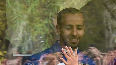 His sons and daughter shared a final moment together, pressing their hands against the class of the bus before the crew left for the launchpad. AFP