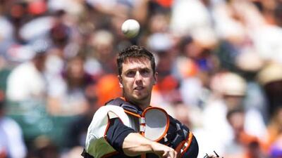 Buster Posey of the San Francisco Giants throws to first base after fielding a bunt against the Arizona Diamondbacks during the third inning at AT&T Park on July 13, 2014, in San Francisco, California. Jason O Watson / Getty Images