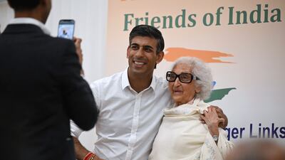 Rishi Sunak poses with a woman at an event in London hosted by the Conservative Friends of India group. PA