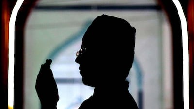 A boy prays during the holy holy fasting month of Ramadan, in Karachi, Pakistan. EPA